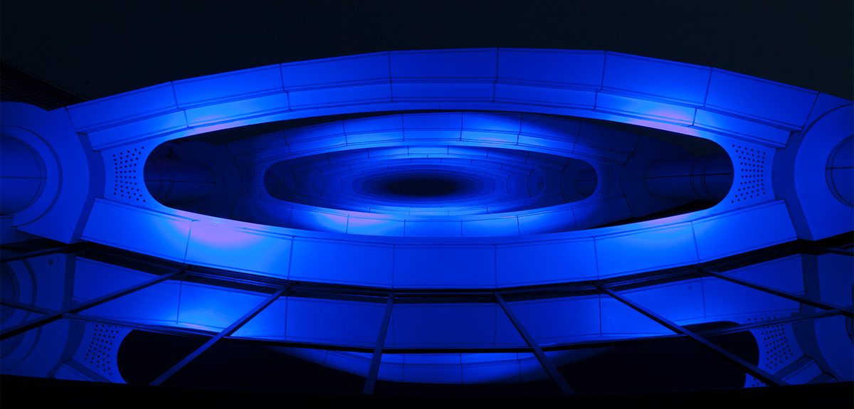 Jumeirah Beach Hotel facade lit in magenta at night