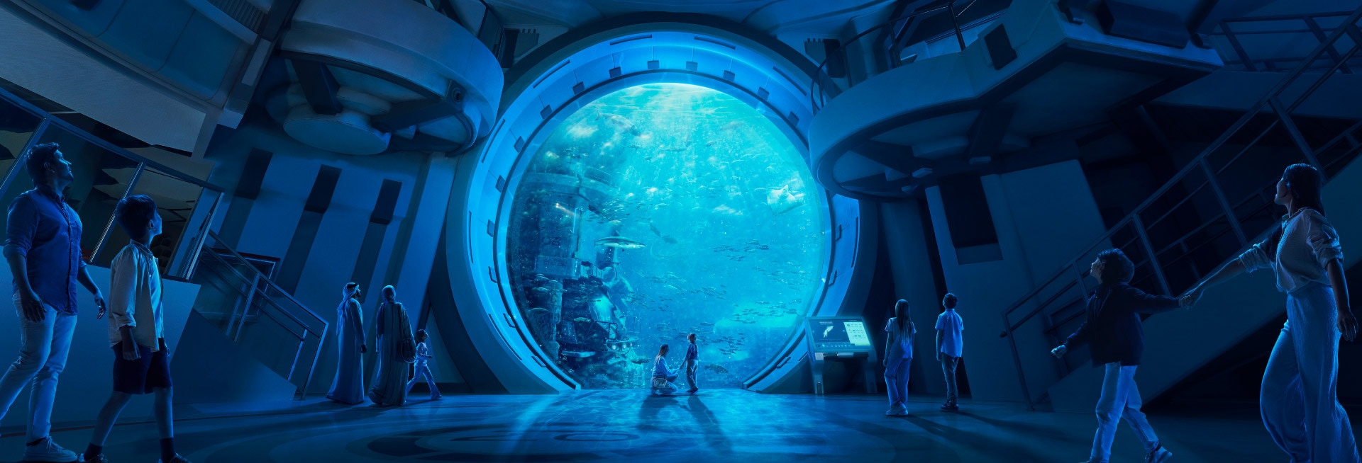 Visitors silhouetted against the massive circular aquarium viewing portal