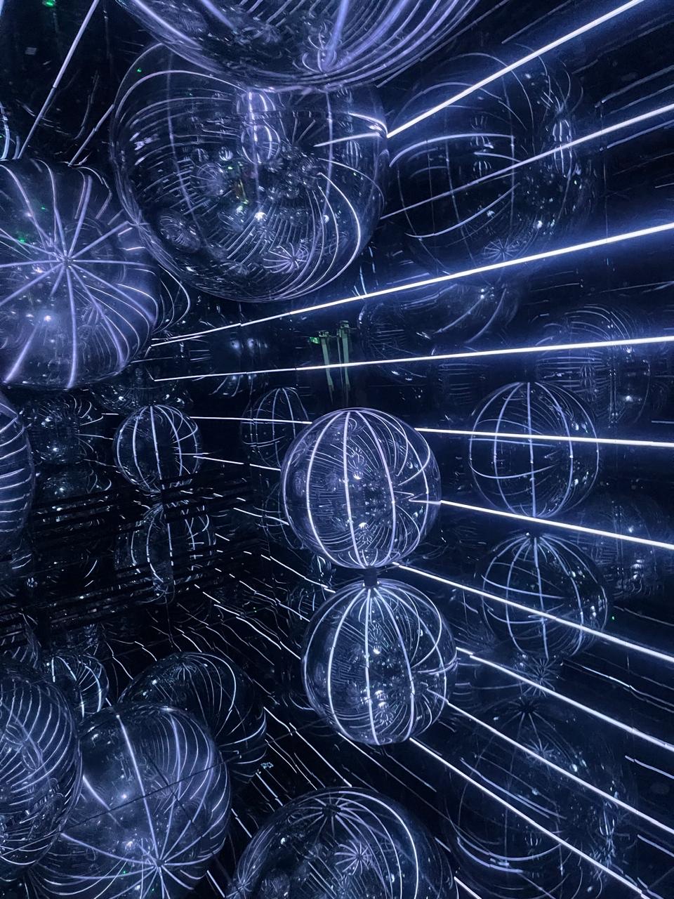 Glass orb room with LED light traces in deep blue