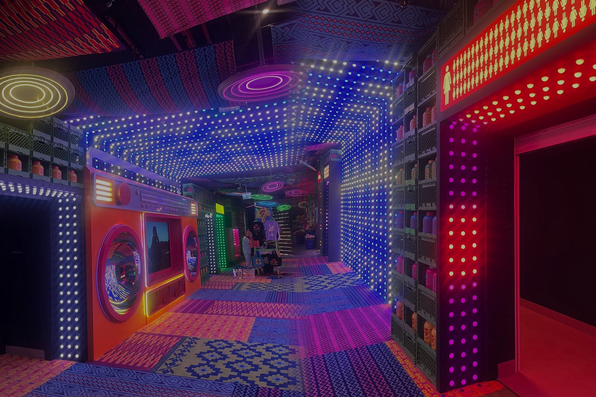 Immersive laundromat room with thousands of pixel-mapped LED dots covering walls and ceiling